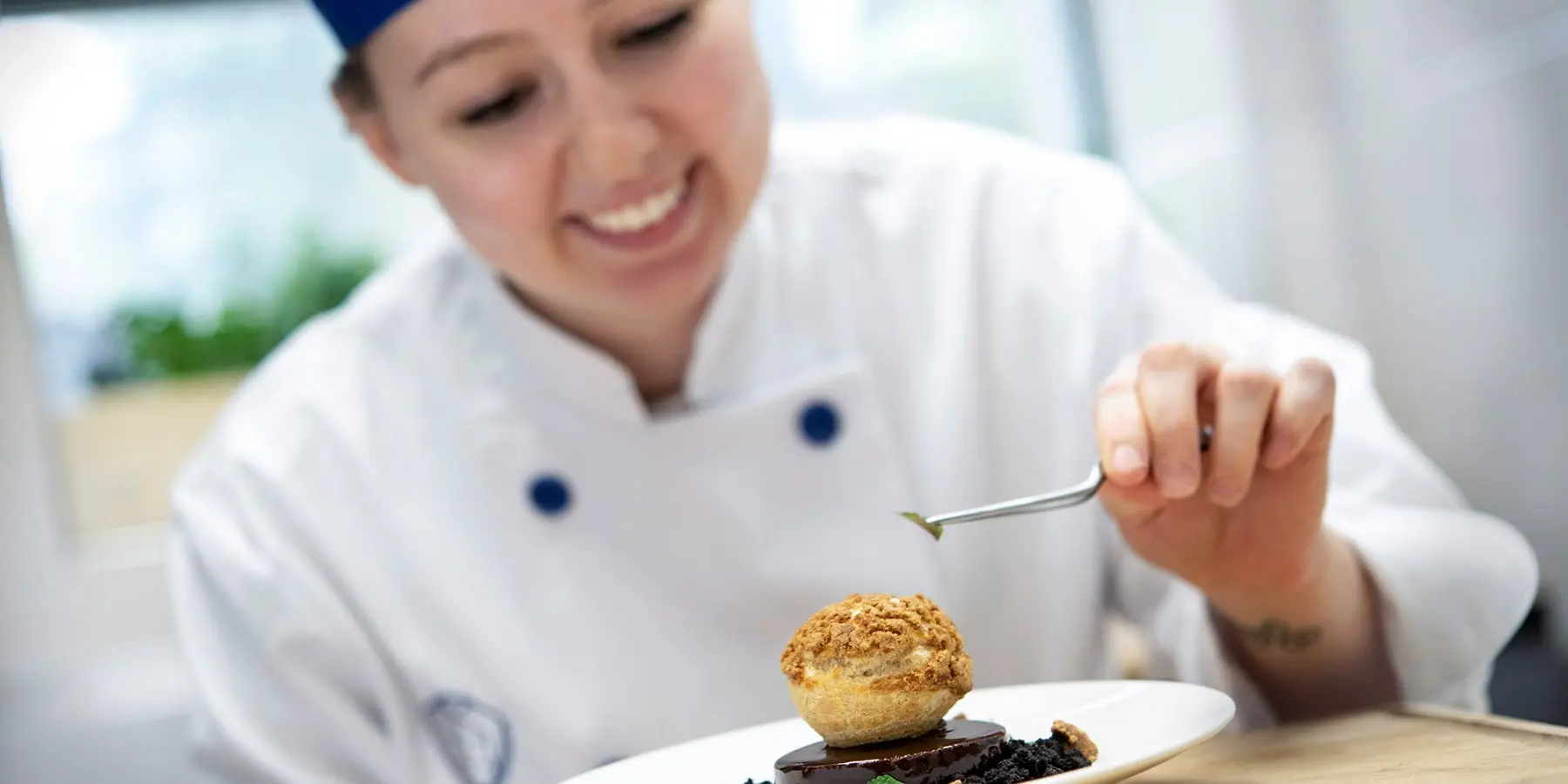 A PICAchef student plating a dessert